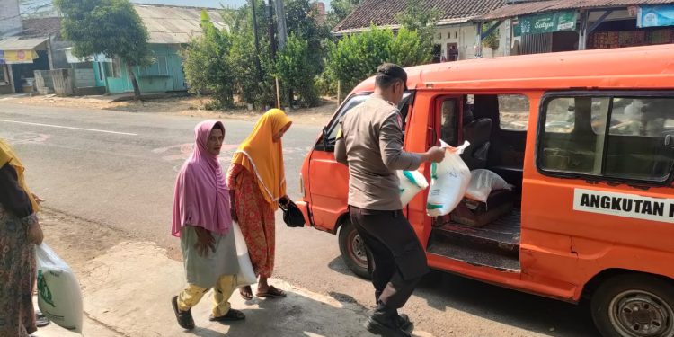 Bhabinkamtibmas Polsek Lembursitu Bantu Warga Jompo Penerima Beras Bantuan Pemerintah